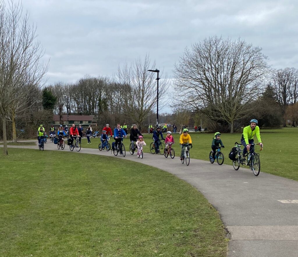 Happy kids - and adults - riding safely in a park