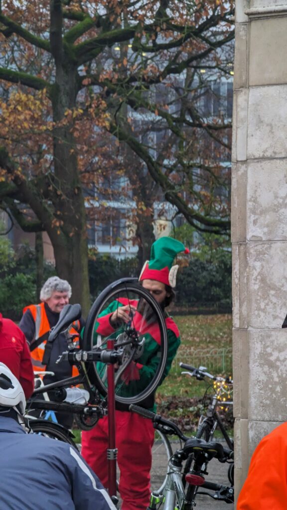 Santa's elf fixing a bike